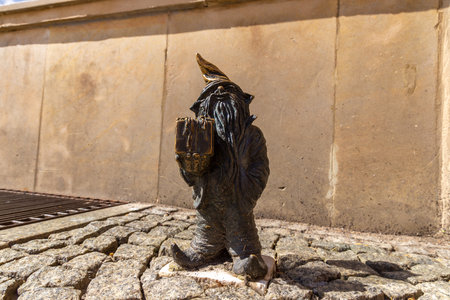 WROCLAW, POLAND - SEPTEMBER 21, 2022: Symbol of Wroclaw - Sculpture of dwarf (gnome) from fairy-tale in a sunny day, Wroclaw, Polandのeditorial素材