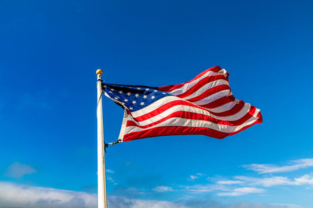 USA flag waving against sky with beautiful cloud