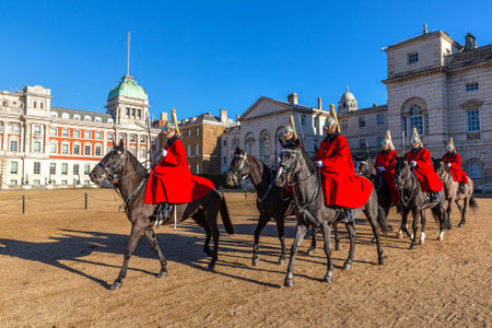 LONDON, UK - JANUARY 30, 2025: Household Cavalry soldiers in red ceremonial uniforms and gold helmets perform The King's Life Guard Change at Horse Guards Parade, a British military traditionのeditorial素材