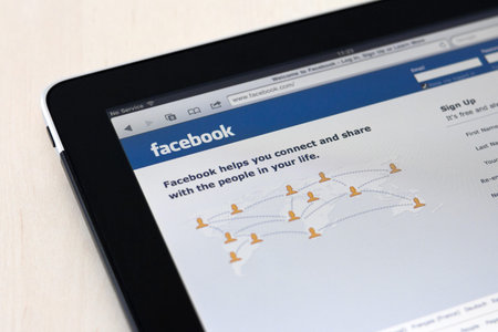 Kiev, Ukraine - May 17, 2011: Apple Ipad showing Facebook start page on screen