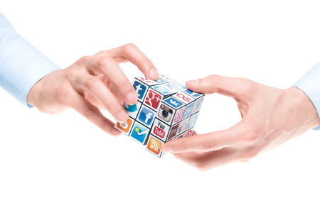 Kiev, Ukraine - February 2, 2013: A hands holding rubik cube with logotypes of well-known social media brandのeditorial素材