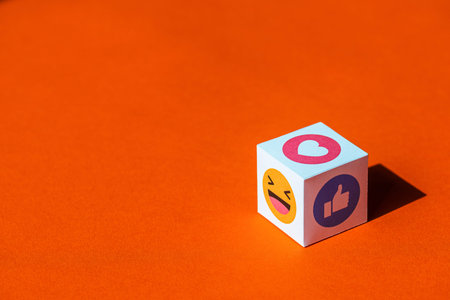 Kyiv, Ukraine - September 9, 2019: A paper cubes with printed emojis from Facebook Messenger, one of...