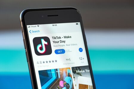 Kyiv, Ukraine - September 17, 2019: Studio shot of Apple iPhone 8 smartphone with TikTok mobile application on the screen, from the download page on App Store platform.のeditorial素材