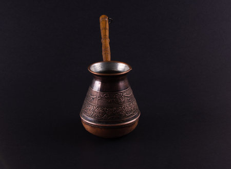 Turkish Style Coffee Pot. Copper Cezve on Dark Background.