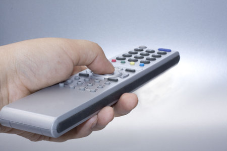 Silver remote control in hand