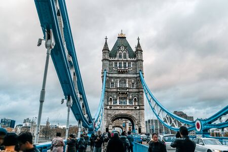 Tower Bridge in London city, United Kingdom with thick clouds on the background. Blurred facesの写真素材