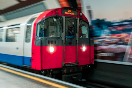 A picture of tube or train captured in motion or with panning technique in London, UK with unrecognizable person's faceのeditorial素材