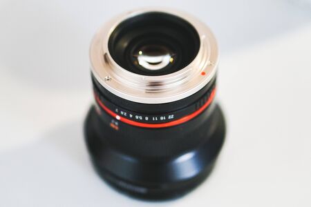 A black camera lens upside down revealing the mount and the shiny lensの写真素材