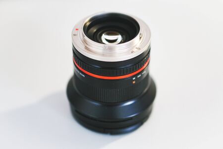 A black camera lens upside down revealing the mount and the shiny lensの写真素材