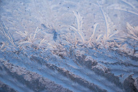Frosty pattern on glass winter windowの写真素材