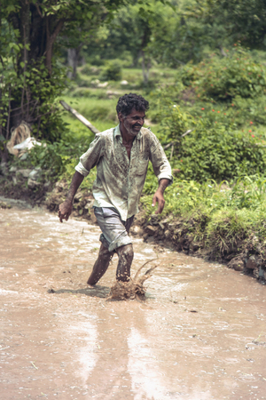 A young farmer doing preparation for rice planting.の写真素材