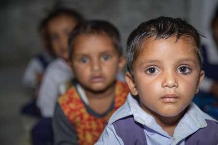 Portrait of Indian rural pre school girls in classroom at village school.の写真素材