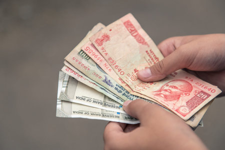 Close up of hand counting Indian rupee notes India