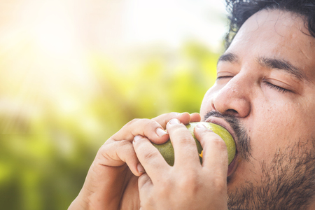 Indian man eating mango.の写真素材
