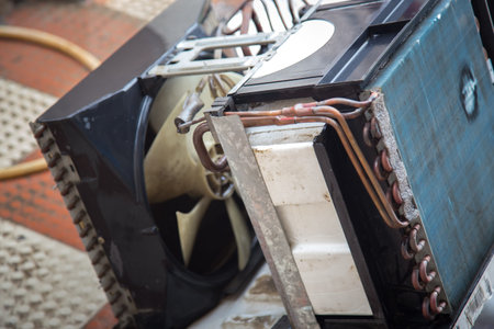 Worker cleaning window air conditioner by water for clean a dust on it in customer home when maintenance service. Breath, repair.の写真素材