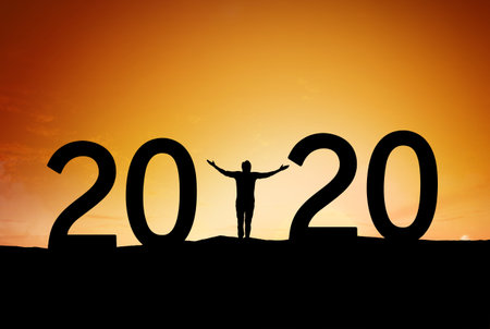Young man standing Silhouette over mountain against blue morning sky to 2020 new year, New year...