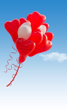 Red and White heart shape baloons flying in the sky, writing spaceの写真素材