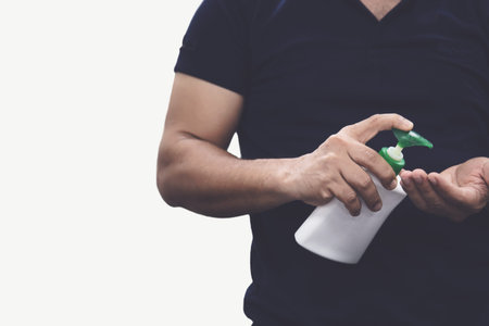 Man using hand sanitizer alcohol gel rub for hands hygiene at home or public space, hospital clinic...