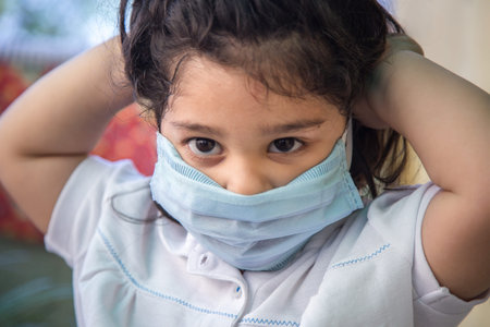 Close up of Indian baby girl wearing the mask for protect them self from virus and air pollution....