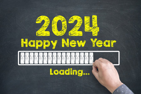 Close up of Human hand Drawing Innovation Technology Loading New Year 2024 on Blackboard Backgroundの写真素材