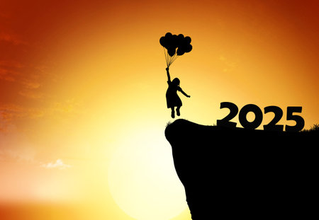 A silhouette of a girl holding balloons leaps off a cliff into a vibrant sunset, symbolizing joy and new beginnings.の写真素材
