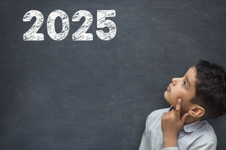 2025 Happy new year school class academic calendar with student kid's hand drawing greeting on teacher's chalkboardの写真素材