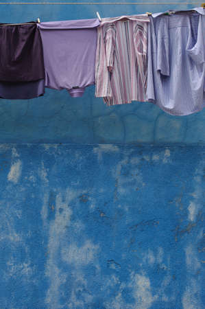 Blue Shirts against a Painted Blue Wallの写真素材