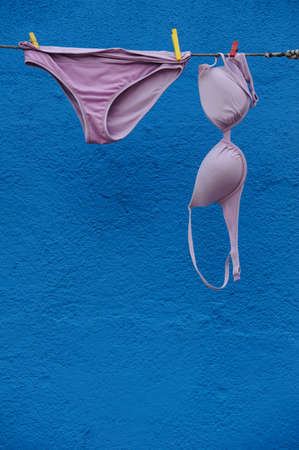 Purple Bra and Pants against Painted Blue Wallの写真素材