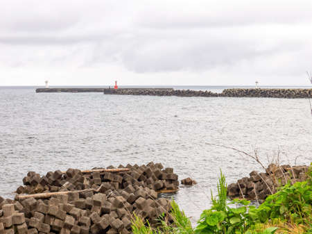 Coast with a lighthouse on a cloudy dayの写真素材