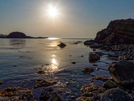 A landscape with a sea surface that reflects sunlightの写真素材