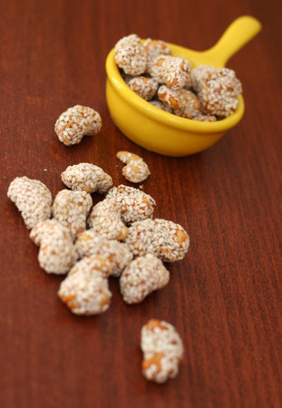 cashew nuts in honey and sesame shellの写真素材