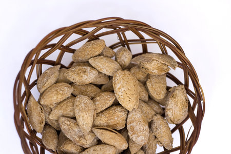 a snack - salted shelled almonds on a white backgroundの写真素材