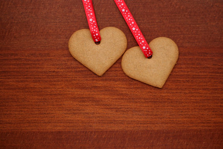 two cookie hearts for valentines day on a table