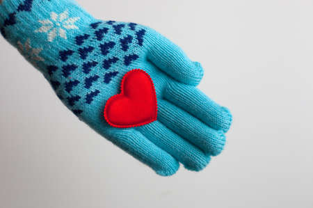Read heart in hand in warm glove on Valentineの写真素材