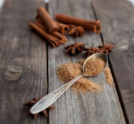 cinnamon sticks and anise stars on rustic wooden backgroundの写真素材