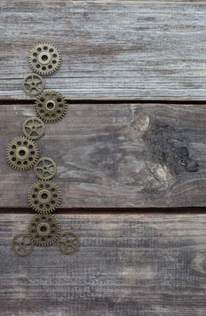 row of steampunk gears on a wooden backgroundの写真素材