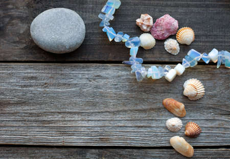 seashells and pebbles on the wooden rustic tableの写真素材