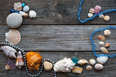 seashells and pebbles on the wooden rustic tableの写真素材