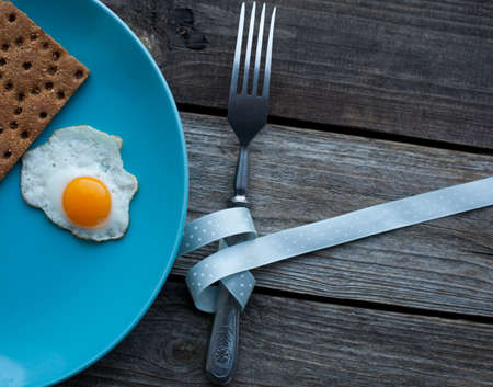 fried quail egg on a turquoise plateの写真素材