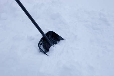 black plastic shovel for snow removal in winterの写真素材