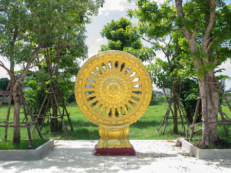 golden thammachak symbol in thailand templeの写真素材
