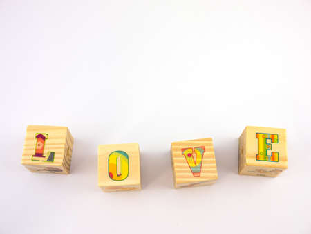 wooden cubic set L-O-V-E on white backgroundの写真素材