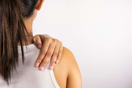 Woman holding her painful shoulderの写真素材