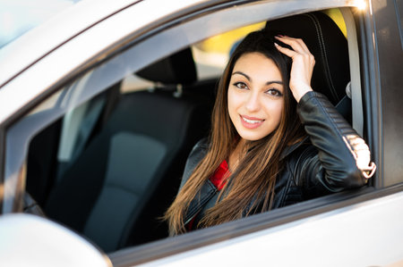 Young woman smiling confidently in her carの写真素材