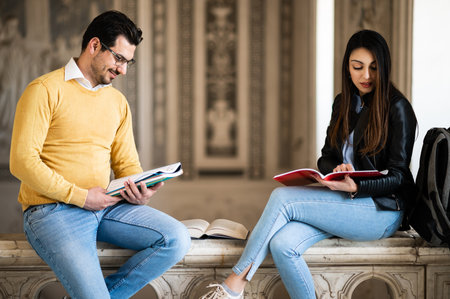 Two students studying indoors in a university hallの写真素材