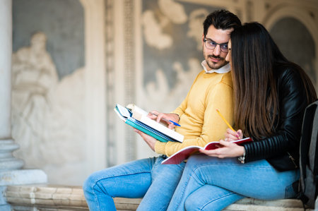 Two students studying indoors in a university hallの写真素材