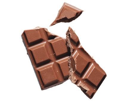 A broken bar of milk chocolate. Candy, snack, junk food.