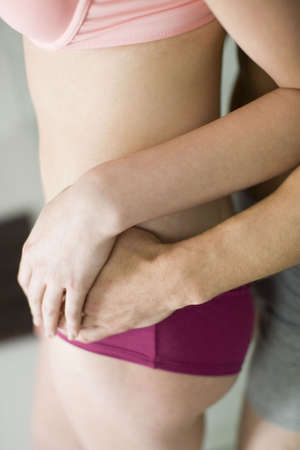 people, couple, man holding a girl's waist from behind, close-upの写真素材