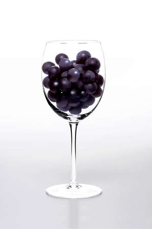 wineglass full of grapesの写真素材