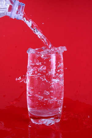 Water spiling out of a glass.